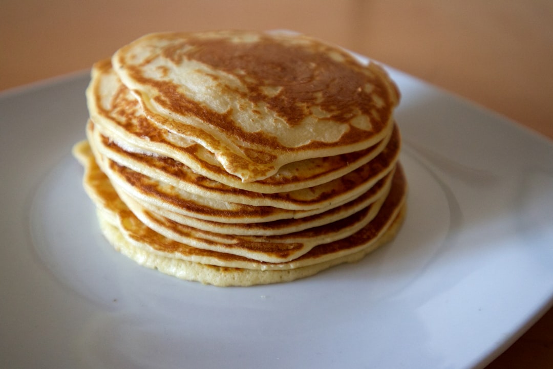 Pancakes Stacked High with Real Maple Syrup (image credits: unsplash)