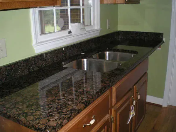 Dark Granite Countertops Are Heavy and Out of Style (Image Credits: Flickr)