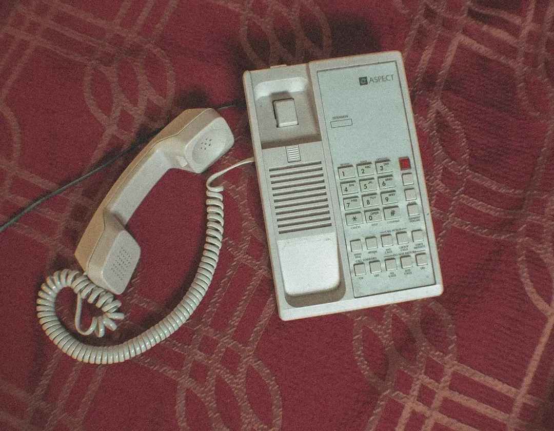 3. A Landline Phone, Still Plugged In (Image Credits: Unsplash)