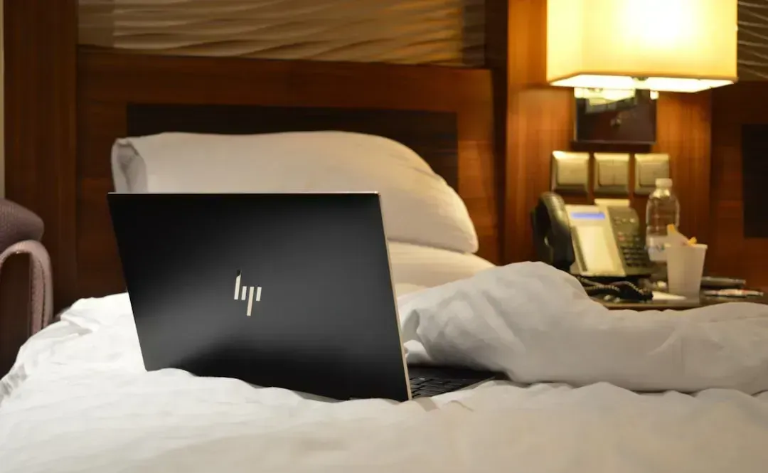 4. Laptops and Tablets Charging on Beds or Sofas (Image Credits: Unsplash)