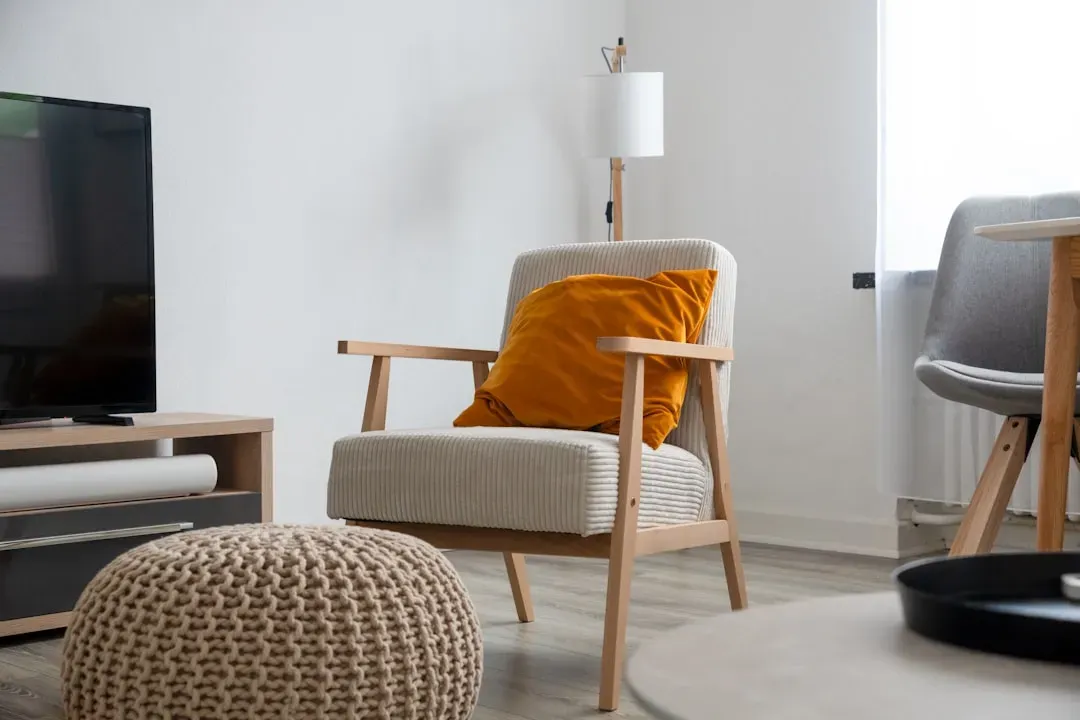 A living room chair set apart from the television (Image Credits: Unsplash)