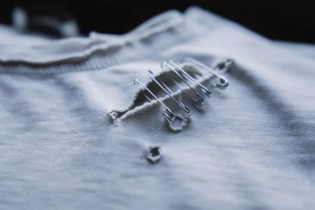 Damaged, Stained, or Pilled Clothing (Image Credits: Unsplash)