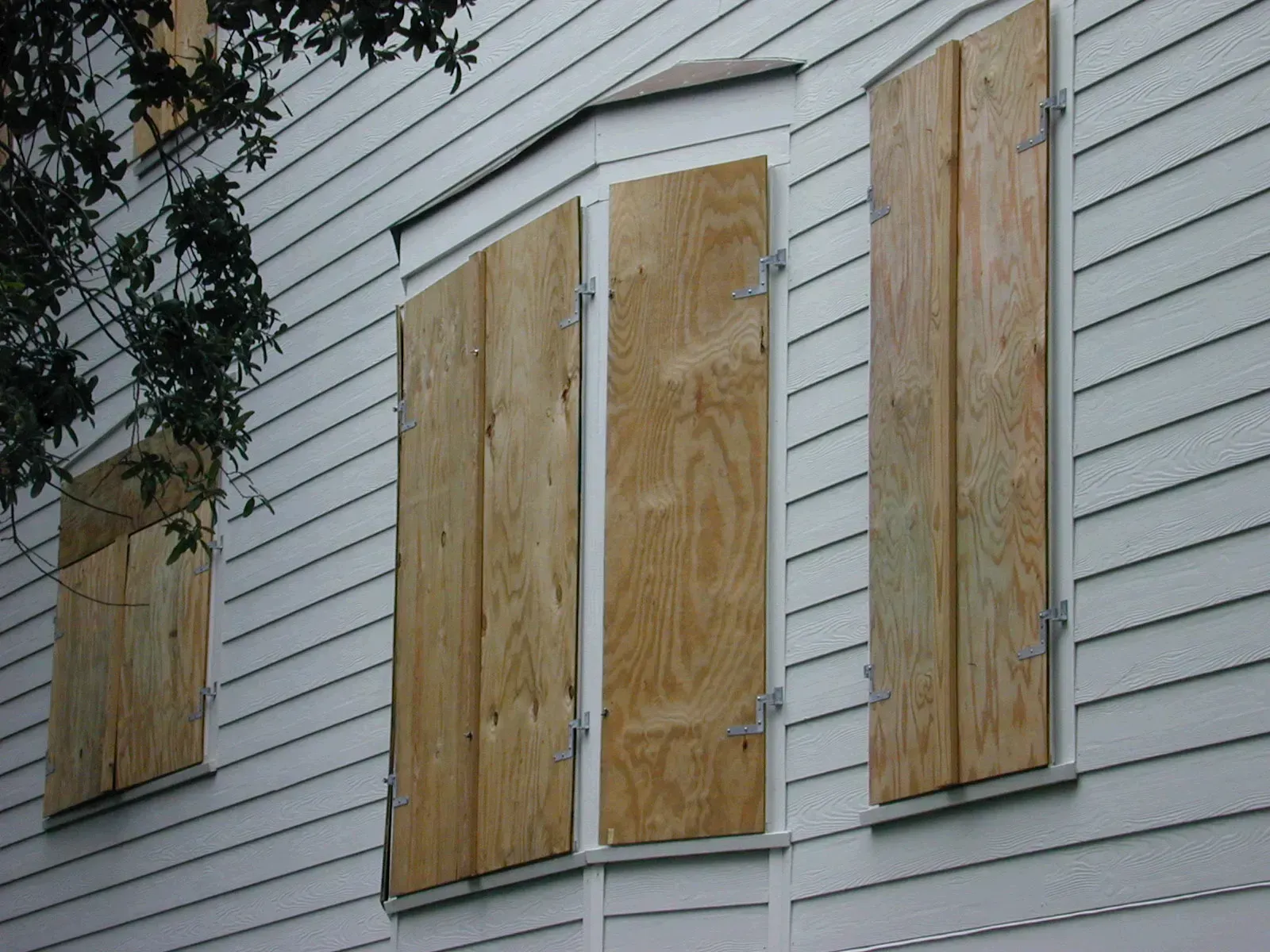 Hardening a home before the wind arrives (This image is from the FEMA Photo Library (obsolete as of 2019).An archived copy may be found at the Wayback Machine (note: link may be permanently dead, as not all photos were backed up in this way).If the FEMA link is permanently dead, the photo can be found at NARA Access to Archival Databases (only works if photo was taken between 1989 and October 2004), or at City-data.com., Public domain)