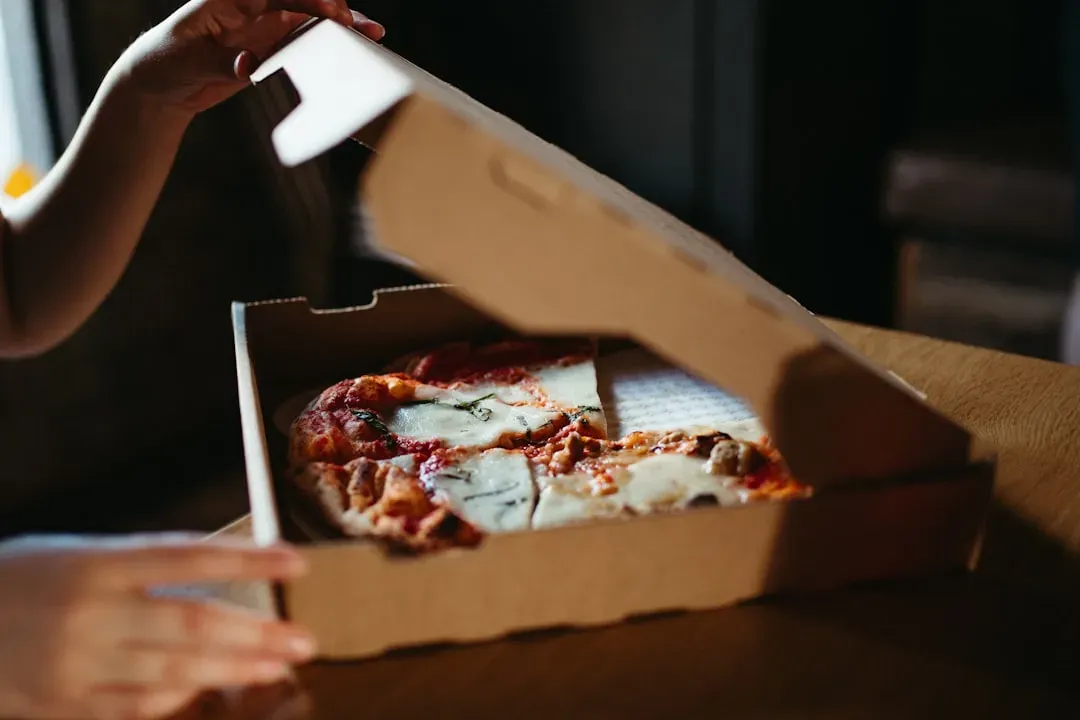 2. Greasy pizza boxes and food-soiled containers (Image Credits: Unsplash)