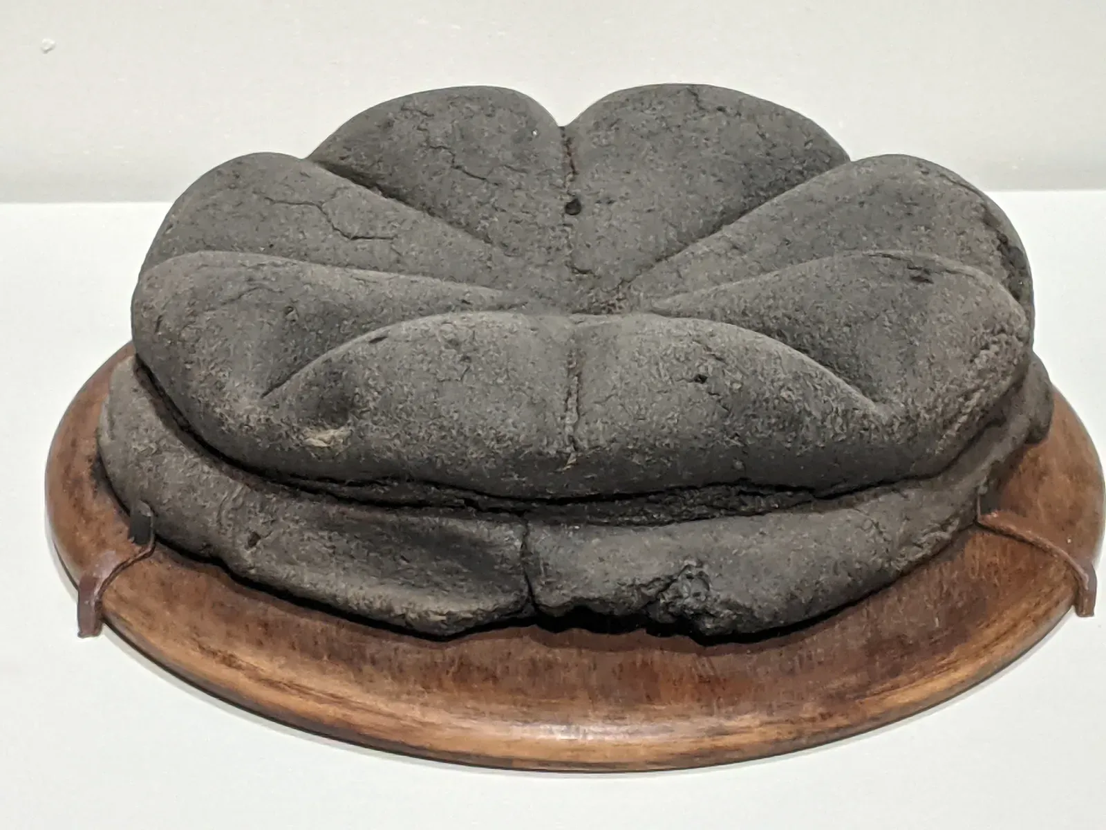 #1 The Pompeii Loaves of Bread That Survived a Volcanic Apocalypse (A loaf of carbonized bread, CC BY 2.0)