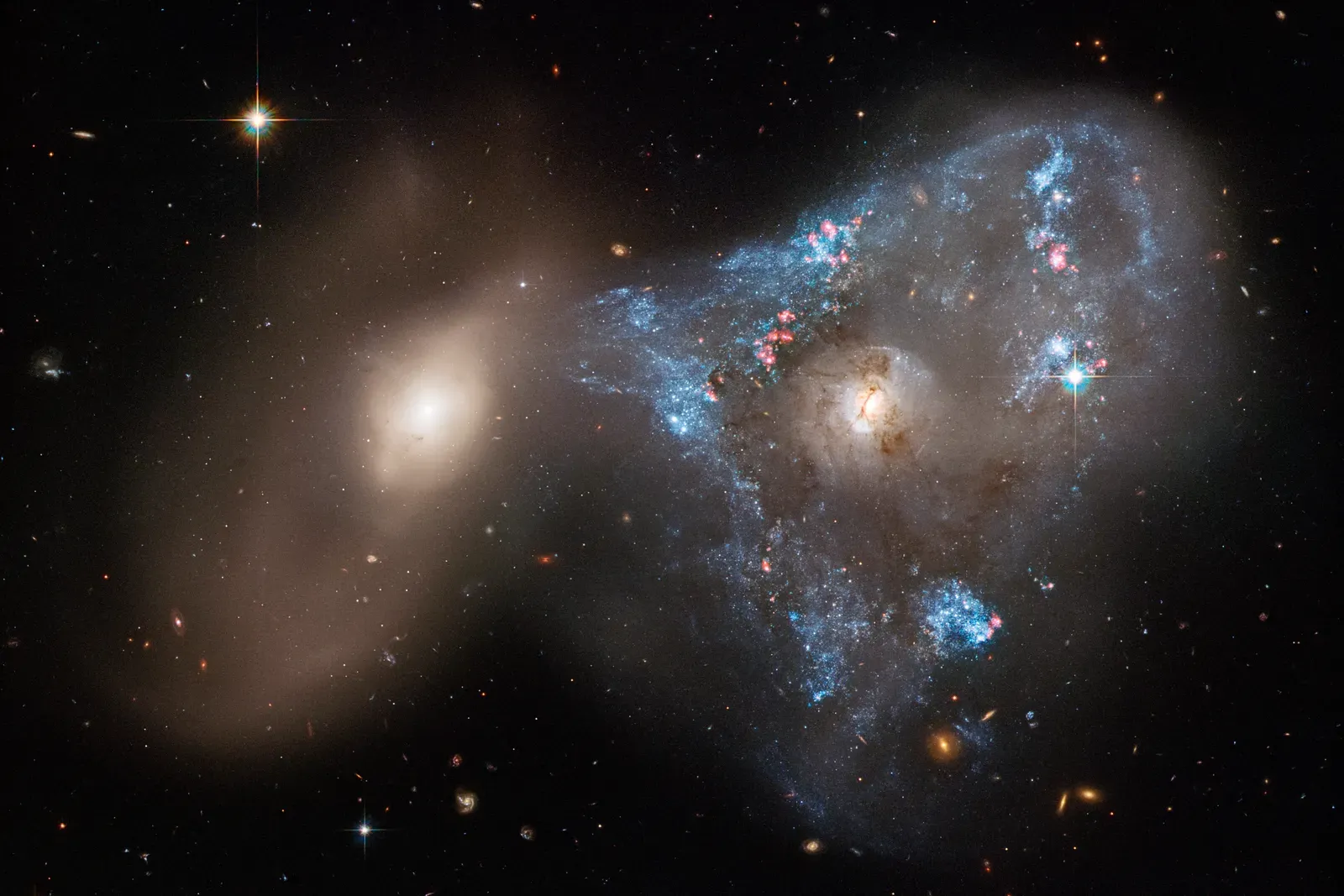 Star Birth in the Chaos: How Collisions Light Up the Universe (Hubble looks at a ‘Space Triangle’ spawned by a galaxy collision, CC BY 2.0)