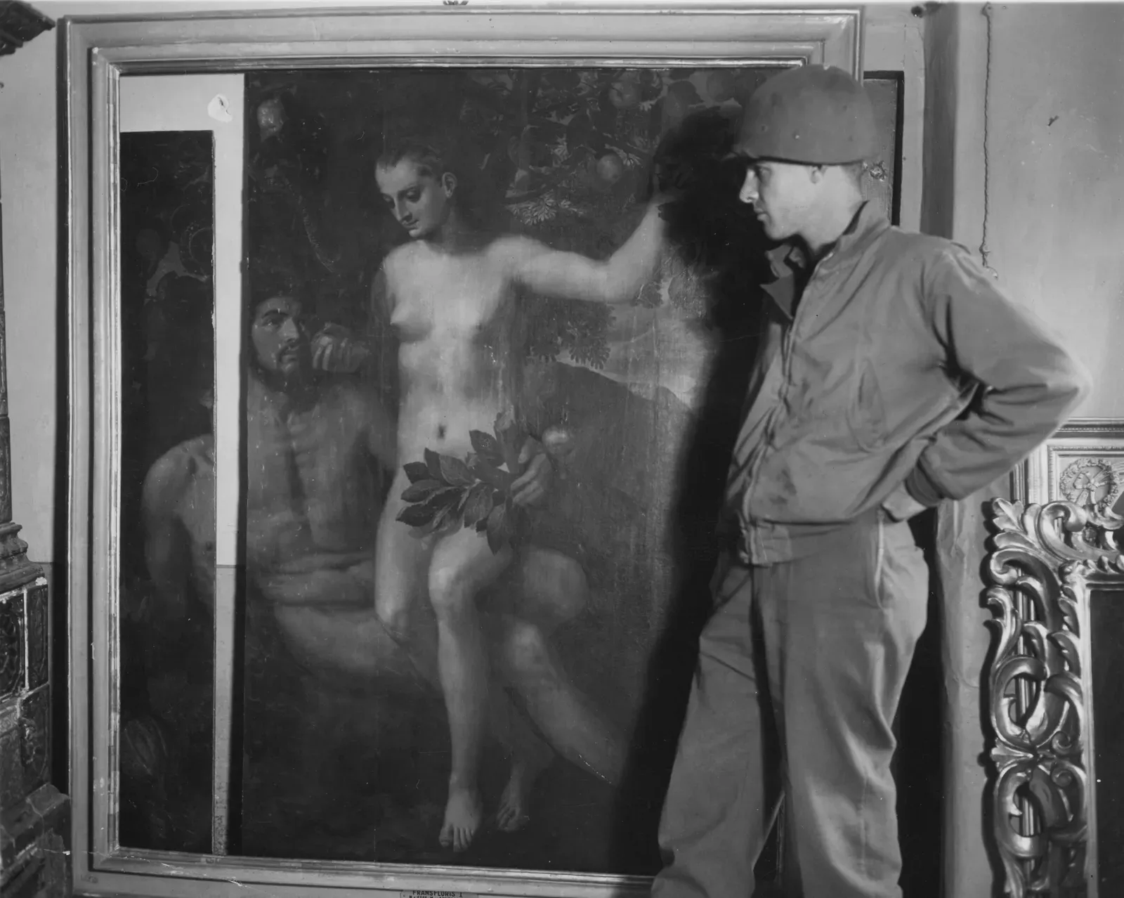 #2. "Recovered" Nazi-Looted Art That Unravels Under Provenance Forensics (SC 374650 - Lt. William S. Leinberger, southern Cal., "C" Battery, 337th F.A. Bn., 88th Div., inspects the Adam and Eve painting by Frans Floris I, which was bruised and torn in transit., Public domain)