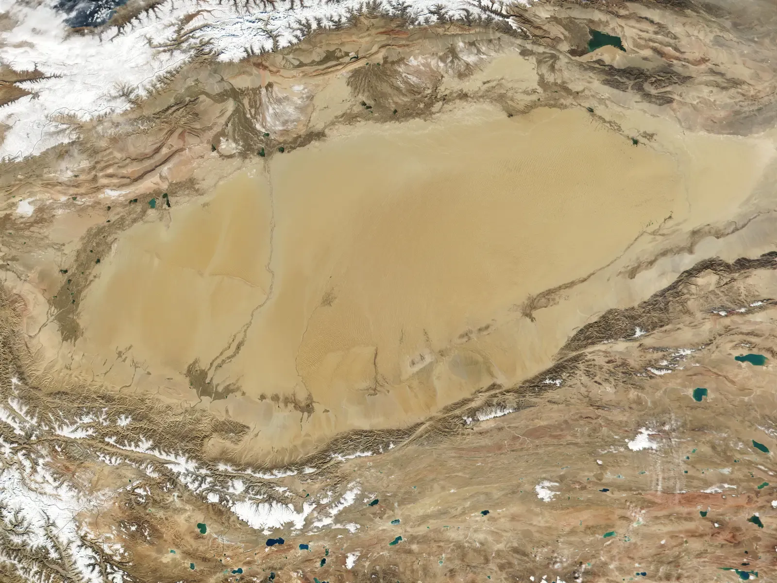 4. The Taklamakan Desert, China: Highways on the Edge of a Sand Ocean (By NASA/GSFC/MODIS Team, Public domain)