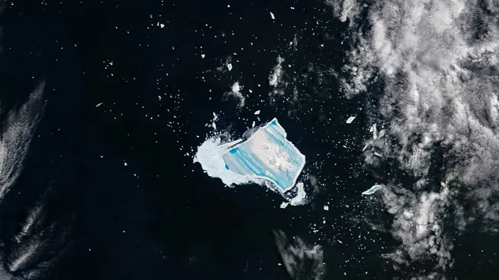 The Birth and Imprisonment of a Frozen Giant (Image Credits: NASA's Terra satellite snapped the mega-iceberg A23a on Dec. 26, revealing a series of vibrant blue striations on its icy surface.NASA)