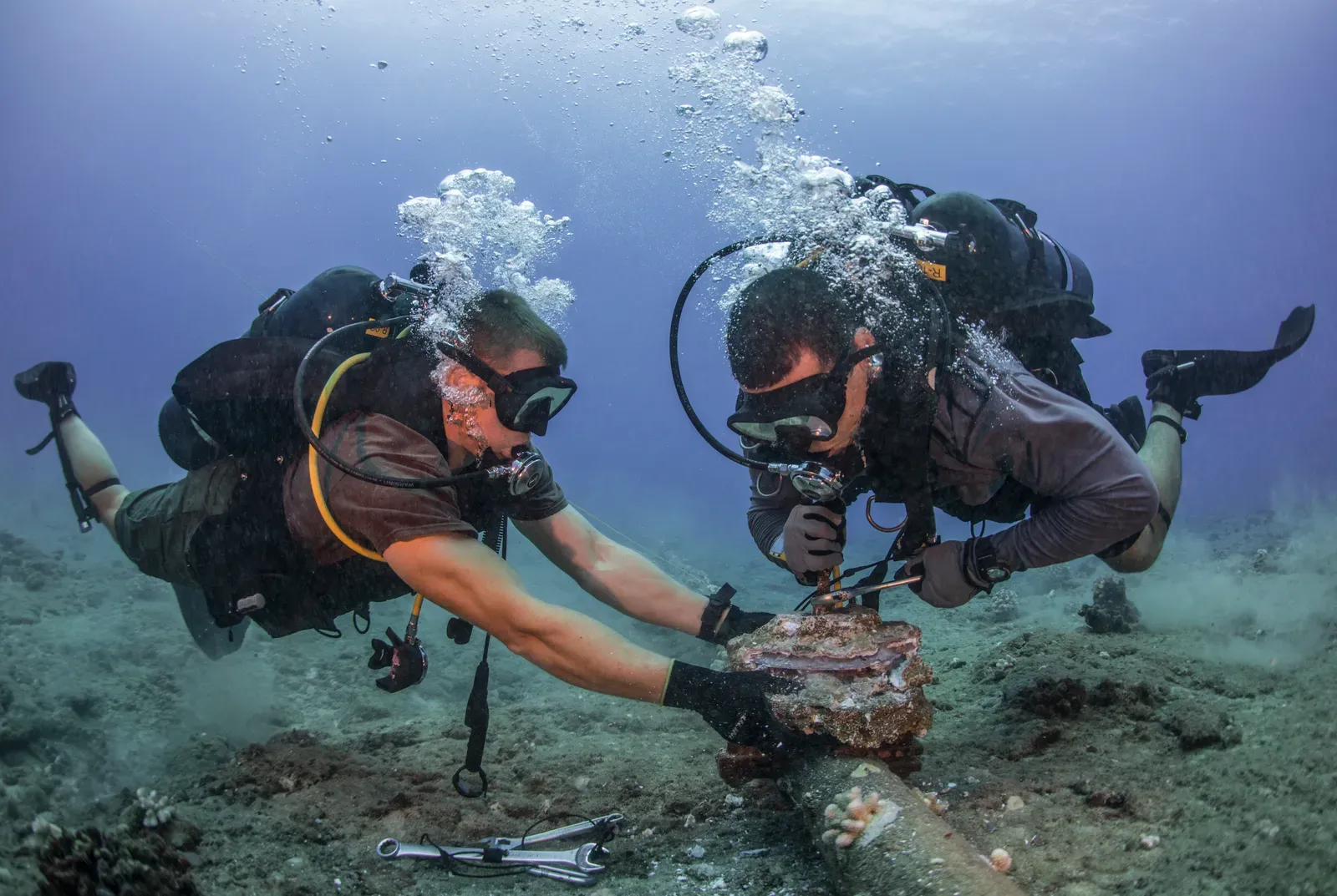 #7 Deep‑Sea Cables And The Mystery Objects Caught On Them (Seabees remove corroded zinc anodes from an undersea cable., Public domain)