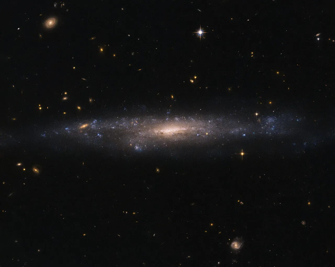 How These Invisible Forces Shape Your Cosmic Future (Hubble Sees Galaxy Hiding in the Night Sky, Public domain)