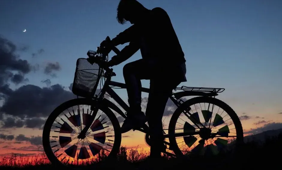 Still Eight: A Boy on a Bicycle Silhouetted Against the Moon (Image Credits: Pexels)