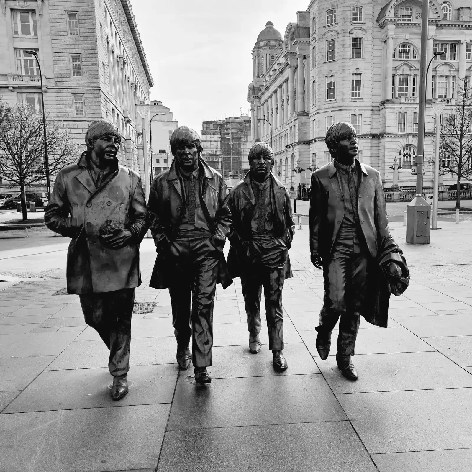 John F. Kennedy (1961–1963): "Please Please Me" by The Beatles (Image Credits: Photo by Ivan Dražić: https://www.pexels.com/photo/black-and-white-photo-of-the-beatles-statue-in-liverpool-england-23834957/)