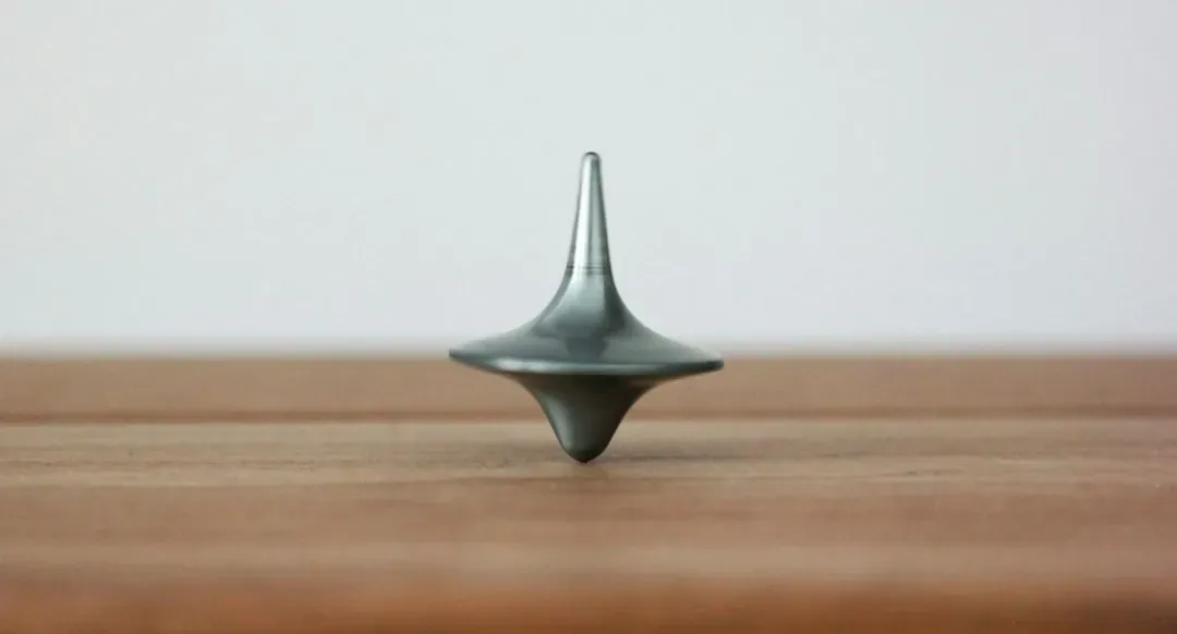 7. A Spinning Top on a Table (Image Credits: Unsplash)