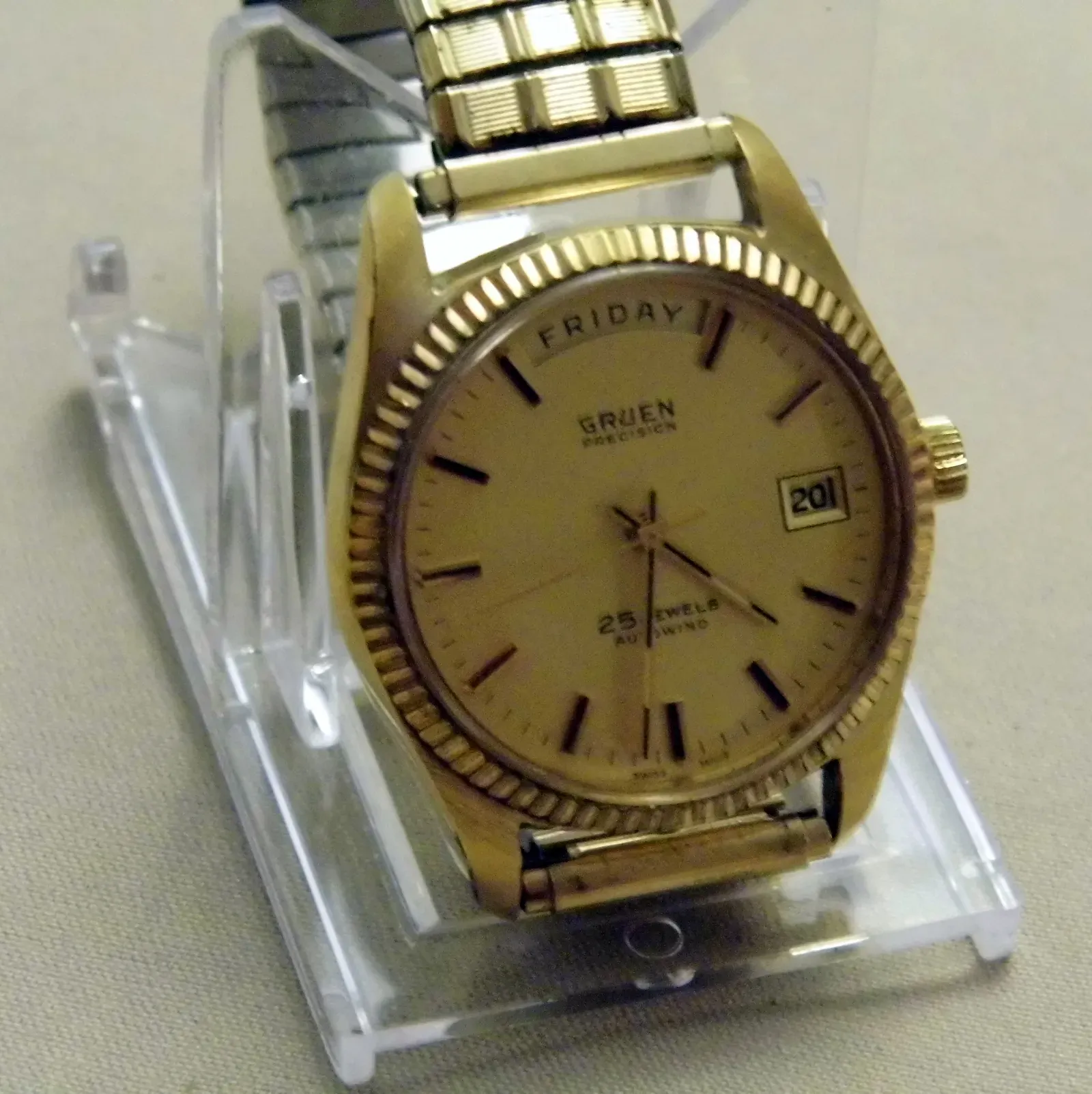 The Wristwatch: From Jewelry to Battlefield to Status Symbol (Vintage Gruen Precision Autowind Men's 25-Jewel Goldtone Wristwatch, Swiss-Made, CC BY-SA 2.0)