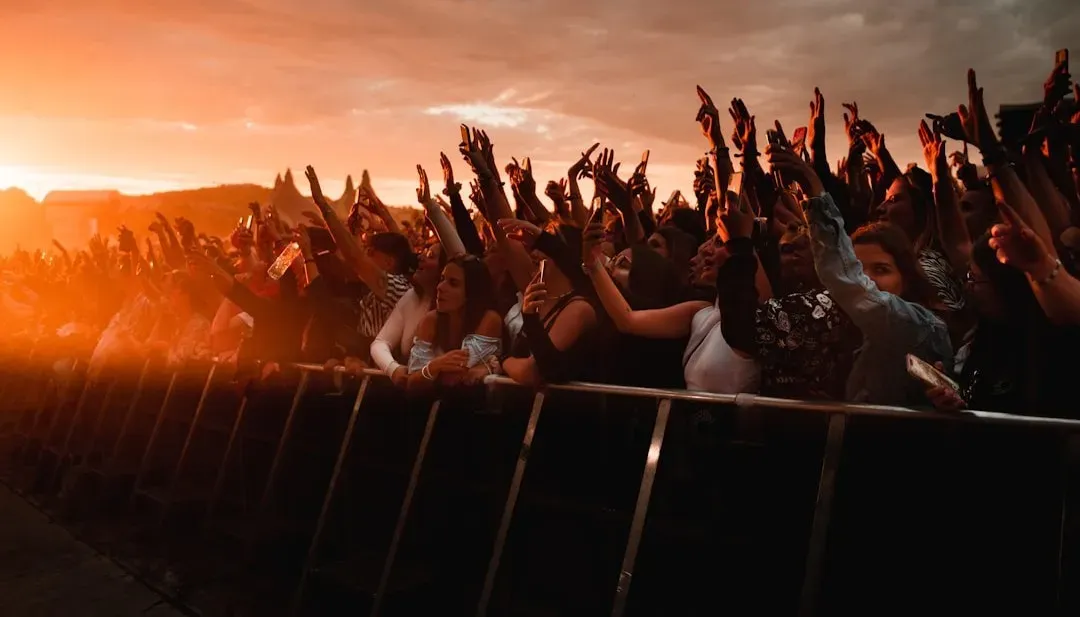 1. Climbing on barricades during the encore rush (Image Credits: Unsplash)