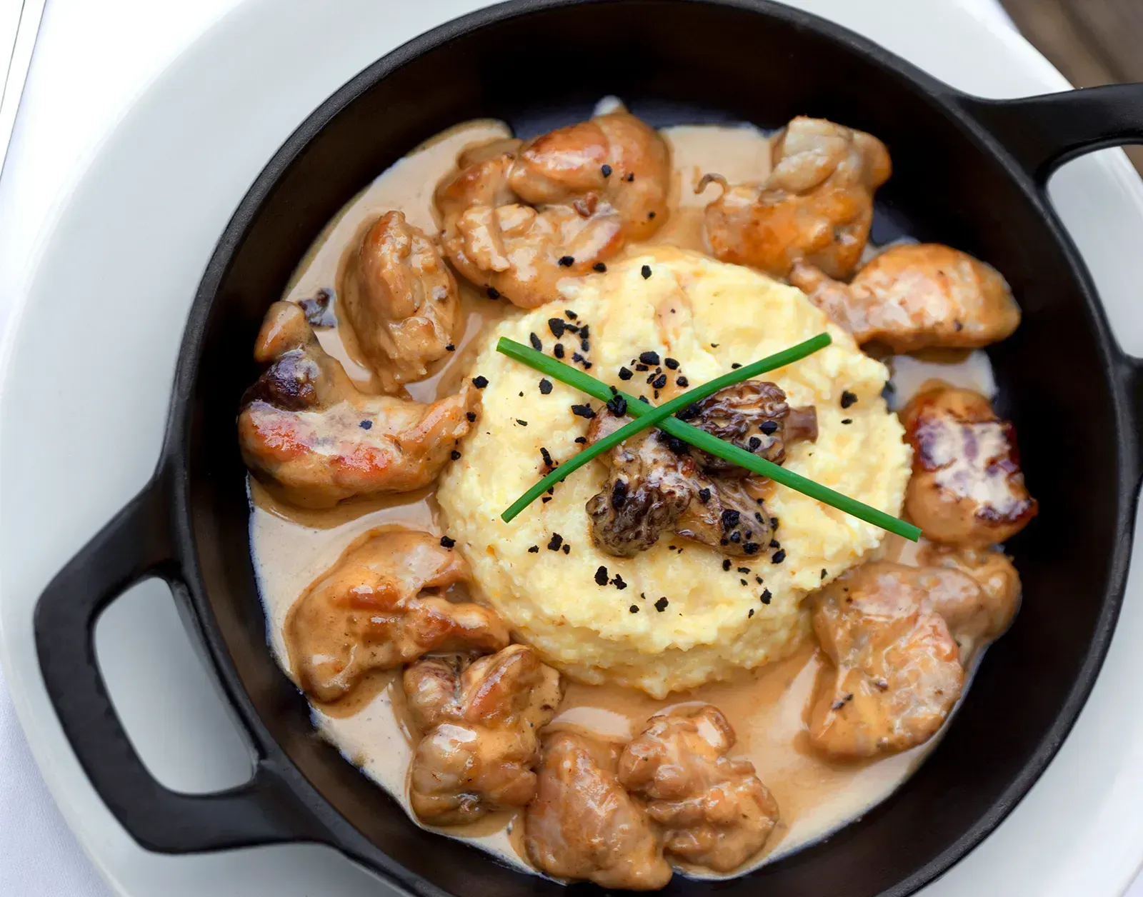 Cockscombs and Sweetbreads (Image Credits: Https://cdn.britannica.com/68/236168-050-7EE30932/Sweetbreads-with-sauce-in-a-dish-made-of-polenta-and-morel-mushrooms.jpg)