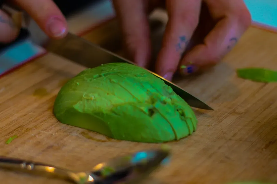 4. Cutting an Avocado in Your Hand (Image Credits: Unsplash)