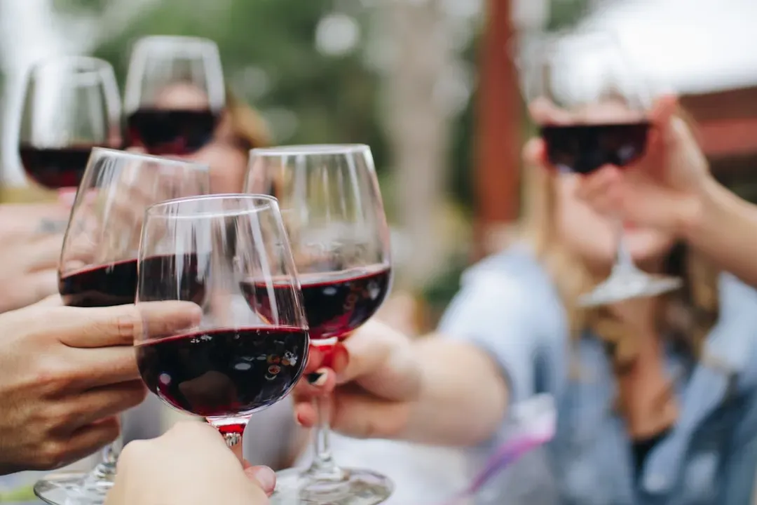 4. Refilling your own glass without offering others first (Image Credits: Unsplash)