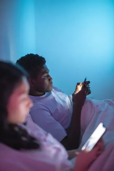 Checking a partner's phone when no one is looking (Image Credits: Pexels)