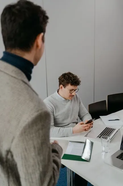 They scroll through their phones during meetings and dinner (Image Credits: Pexels)