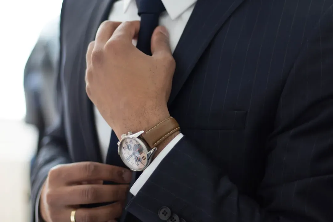 2. Wearing formal business attire as the default (Image Credits: Unsplash)