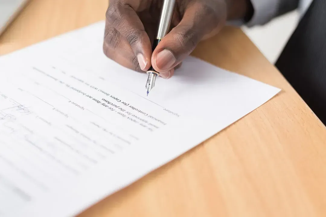 5. Reading a contract before signing it (Image Credits: Unsplash)