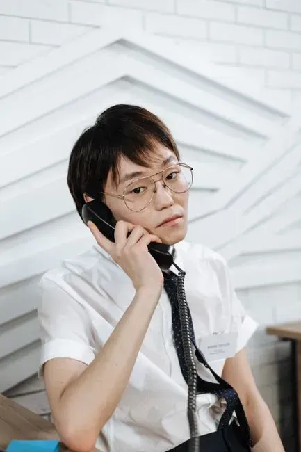 2. Answering the phone and taking a message (Image Credits: Pexels)