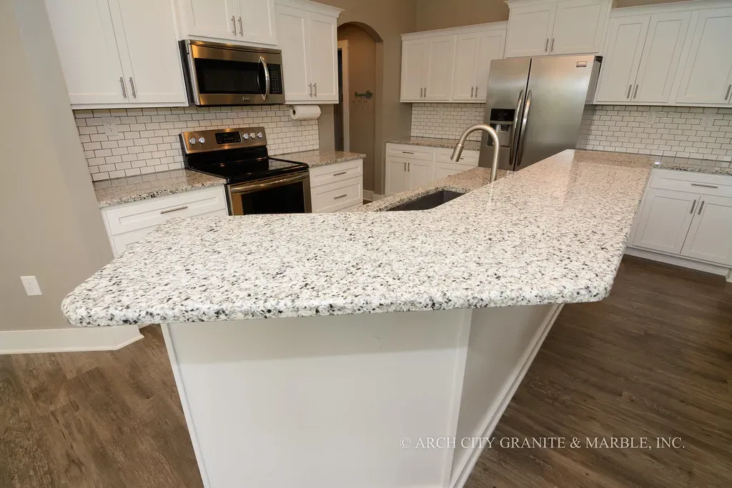 6. Speckled or Busy Granite Countertops (ArchCityGranite, Flickr, <a href="https://creativecommons.org/licenses/by/2.0/" target="_blank" rel="noopener">CC BY 2.0</a>)