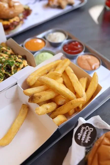 3. Double-dipping serving utensils into your mouth (Image Credits: Pexels)