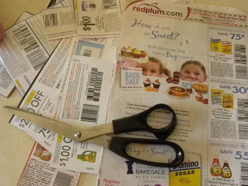 12. Clipping coupons and reading a physical newspaper (Hobbies on a Budget, Flickr, <a href="https://creativecommons.org/licenses/by/2.0/" target="_blank" rel="noopener">CC BY 2.0</a>)