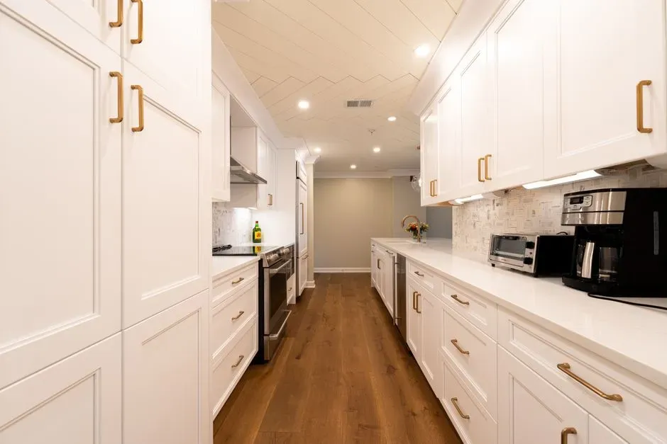The narrow galley corridor with cabinets on both walls (Image Credits: Pexels)