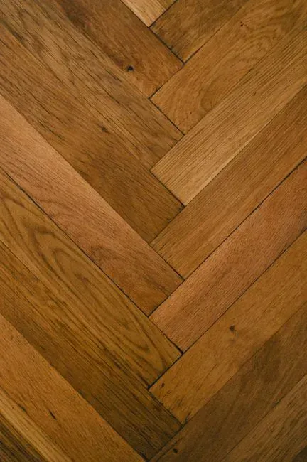 5. Wide-plank or herringbone hardwood floors (Image Credits: Pexels)