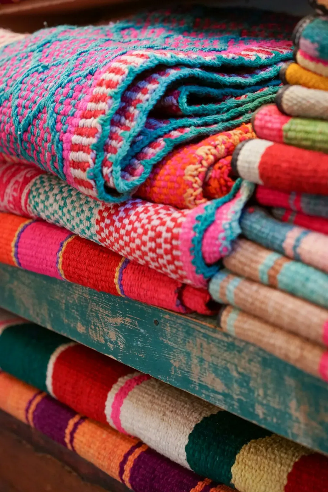 9. Hang a Throw Blanket and Add a Coordinated Accent Rug (Image Credits: Unsplash)