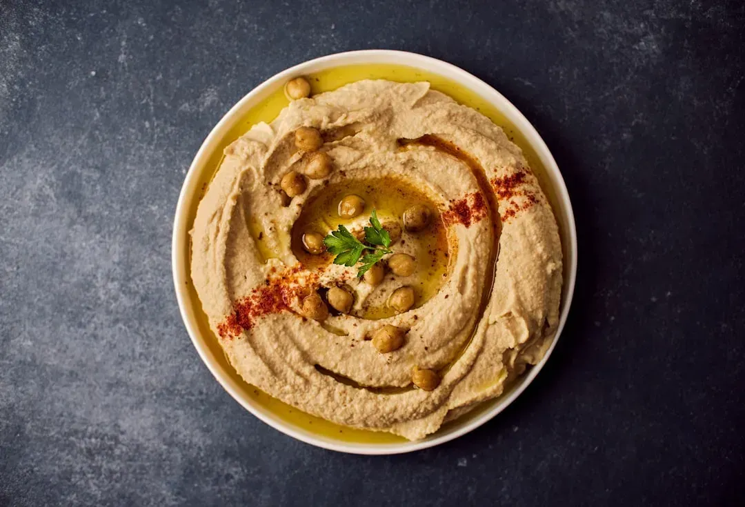Hummus, warm pita, and whatever toppings are around (Image Credits: Unsplash)