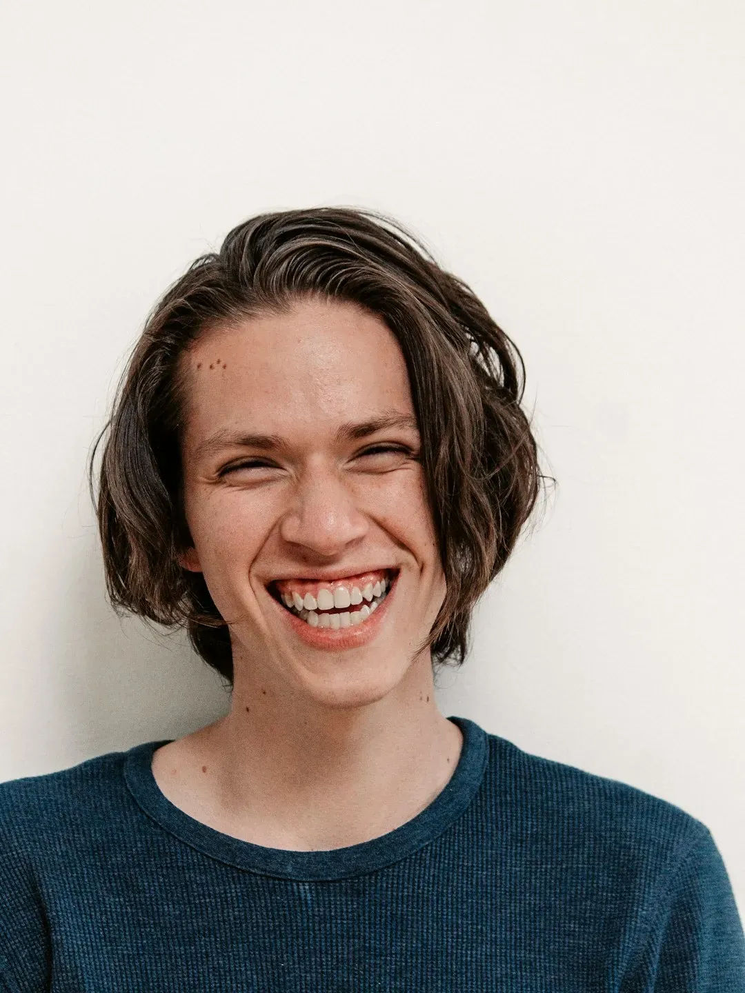 7. They Laugh or Smile Nervously - Even When Nothing Is Funny (Image Credits: Unsplash)