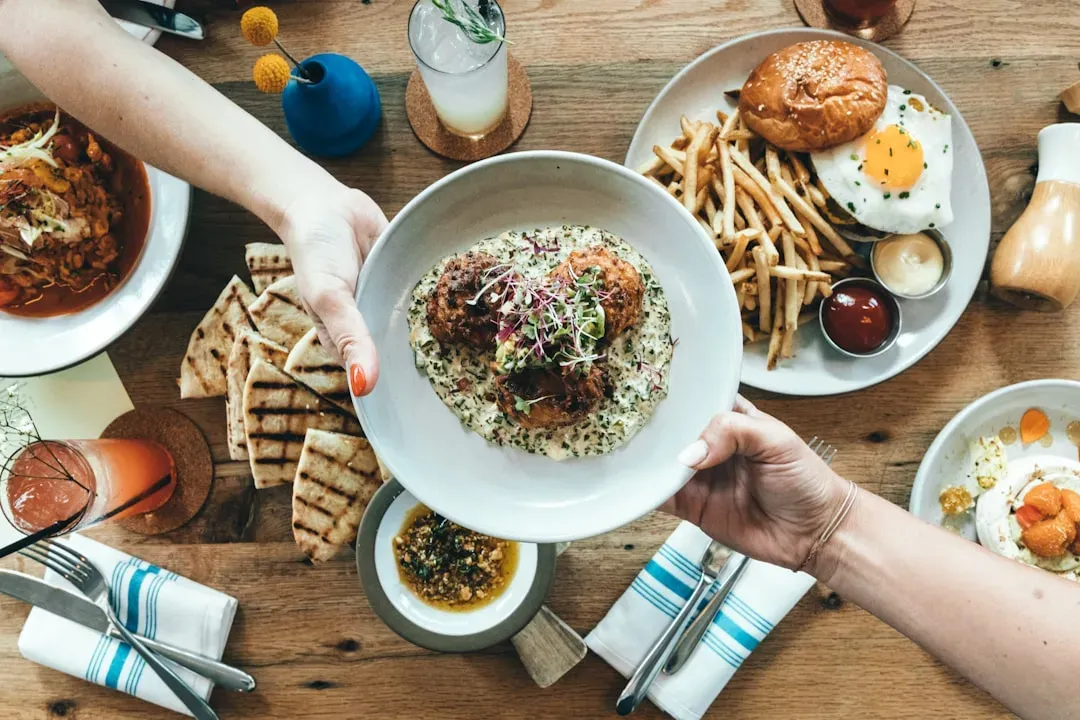 4. Reaching across someone's plate instead of asking (Image Credits: Unsplash)