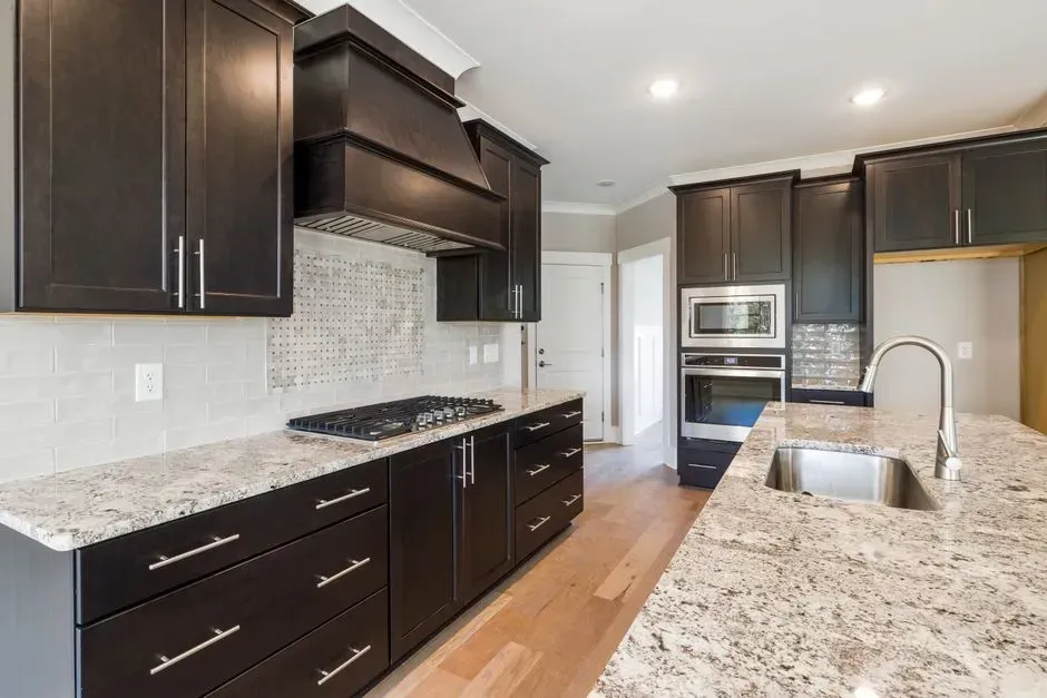 3. Dark wood cabinets and finishes (Image Credits: Pexels)