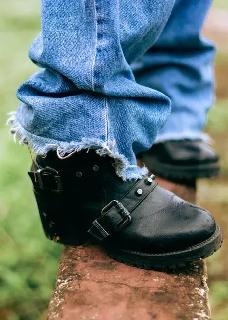 13. Deliberately scuffed or destroyed boots and jeans (Image Credits: Pexels)