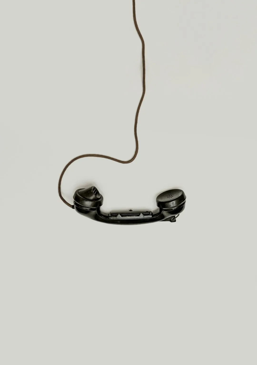 2. A landline phone bolted to the kitchen wall (Image Credits: Unsplash)