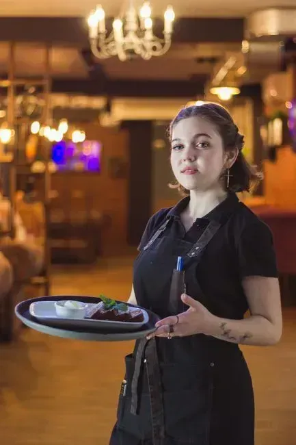 8. Snapping or waving to get a server's attention (Image Credits: Pexels)