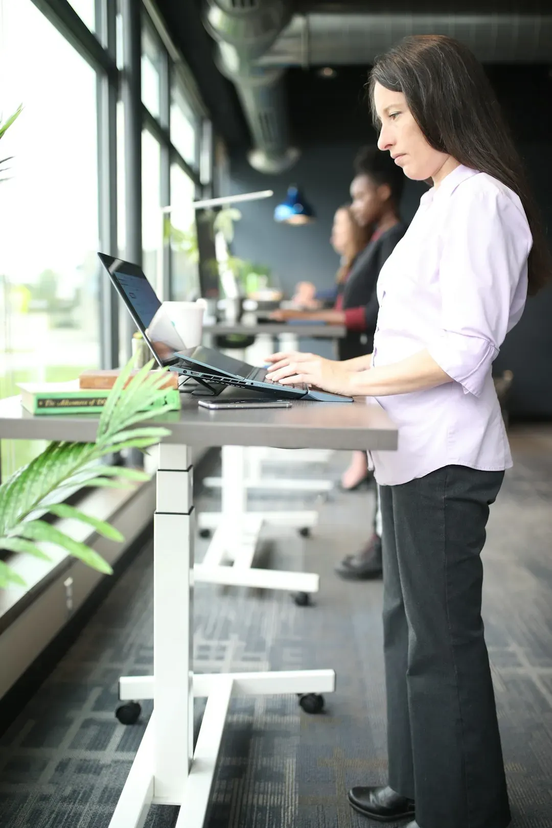 1. Stand and Sit with an Open, Upright Posture (Image Credits: Unsplash)