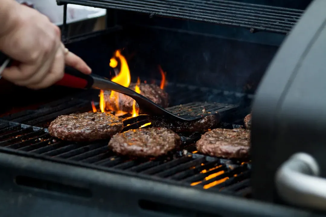 3. Pressing down on the patty while it cooks (Image Credits: Unsplash)