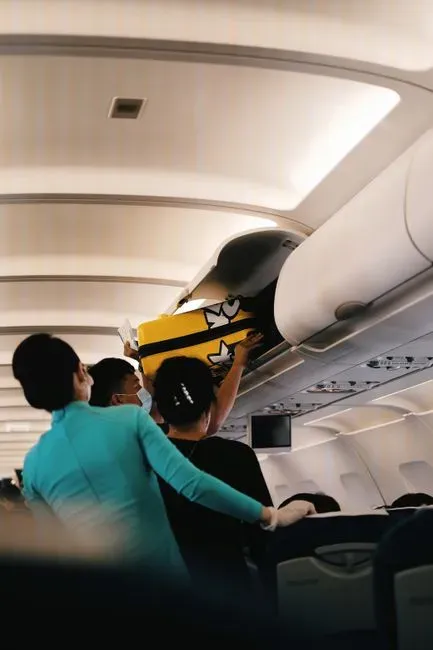 3. The overhead bin isn't your personal storage unit (Image Credits: Pexels)