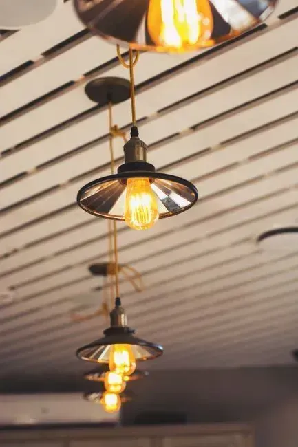 Decorative lighting is replacing industrial fixtures (Image Credits: Pexels)