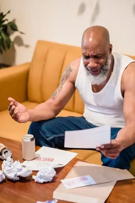 4. Carrying High-Interest Debt Into Retirement (Image Credits: Pexels)