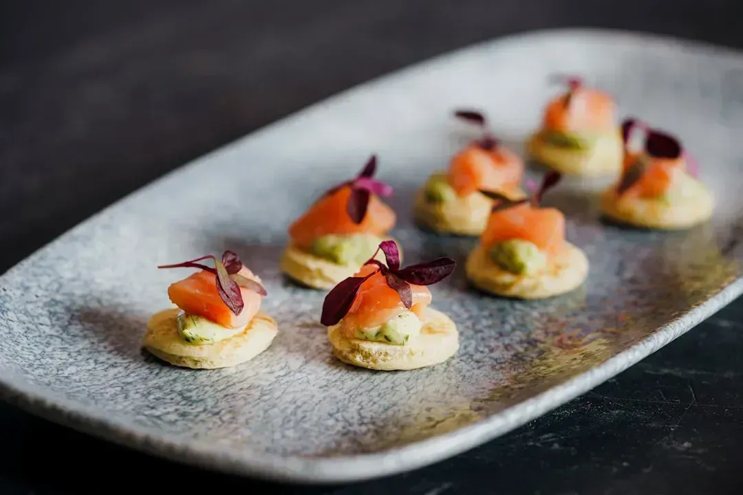 8. Salmon and avocado on whole-grain crackers (Image Credits: Unsplash)