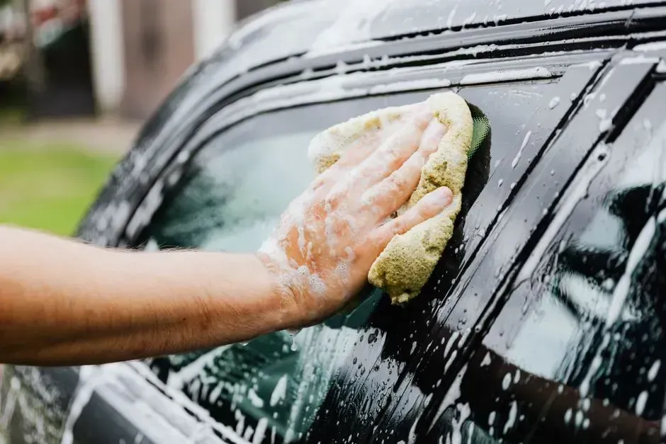 1. Washing the car in the driveway (Image Credits: Pexels)