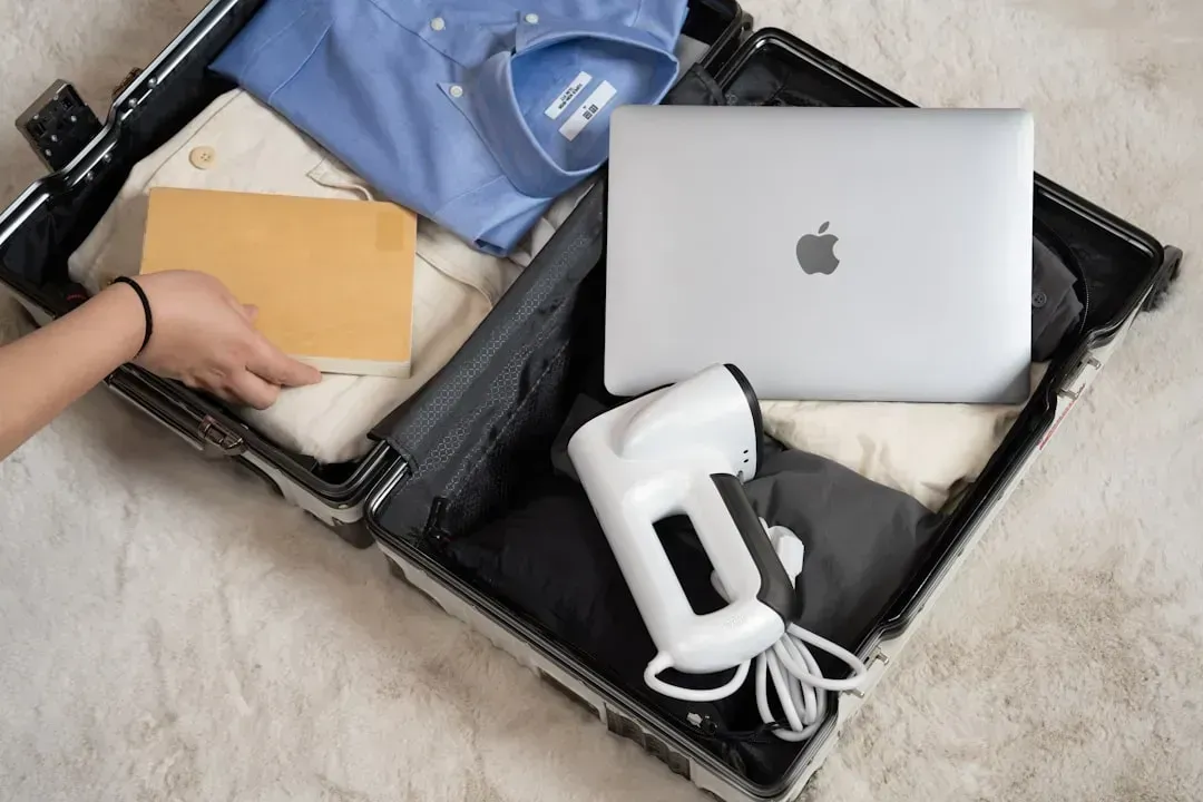 3. Ironing clothes before folding them into the suitcase (Image Credits: Unsplash)