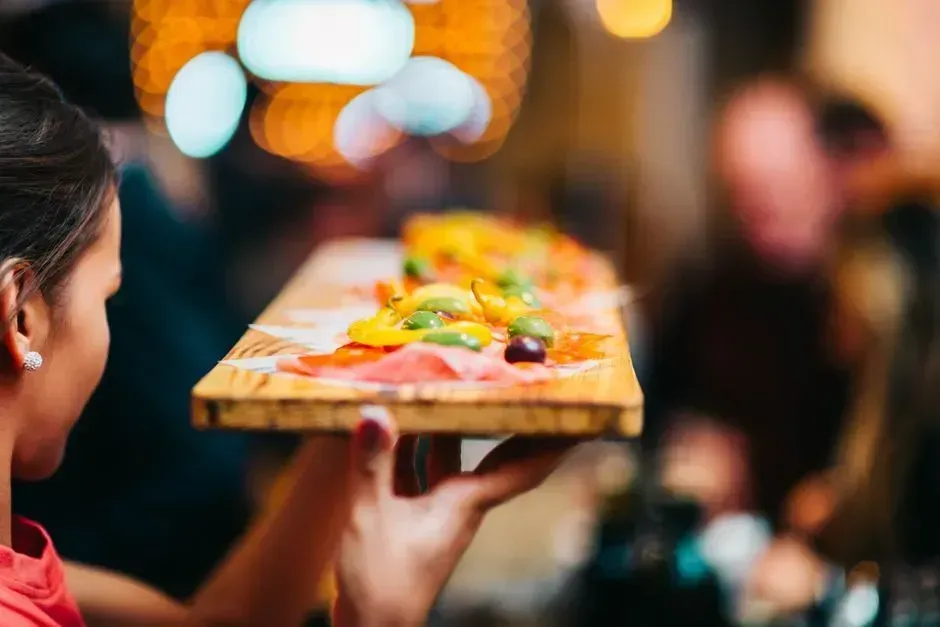 10. Grabbing food or drinks off a passing tray (Image Credits: Pexels)